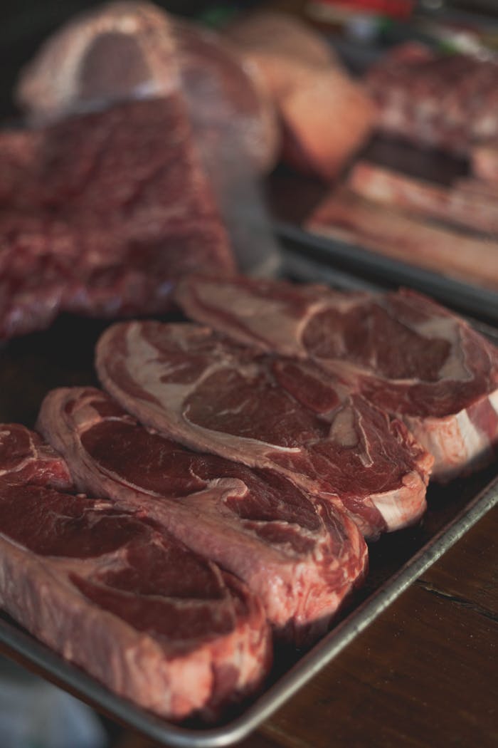 About Fresh raw beef cuts on a tray, perfect for cooking enthusiasts and food markets.